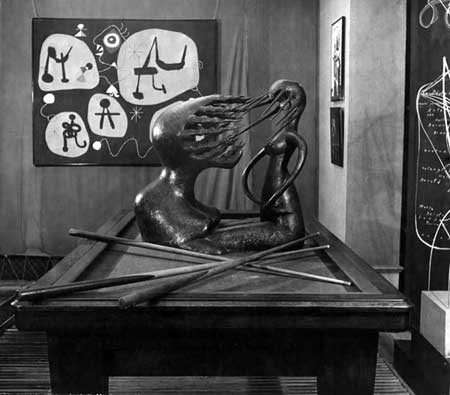 Fig. 7. William Maywald, installation view of the Rain Room in the 1947 “Exposition Internationale du Surréalisme,” Galerie Maeght, Paris, with Maria Martins’s sculpture Impossible on a billiard table and Joan Miró’s Femme entendent la musique in the background. Vintage gelatin silver print on barite paper, Austrian Frederick and Lillian Kiesler Private Foundation, Vienna ©2013 Association Willy Maywald / Artist Rights Society (ARS), New York / ADAGP, Paris ©2013 Austrian Frederick and Lillian Kiesler Private Foundation, Vienna