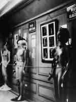 Josef Breitenbach (German, 1896-1984). The Rue Surréaliste, Exposition Internationale du Surréalisme, with mannequins by unidentified artist (left), Léo Malet (center), and Marcel Jean (right); framed photographs by Hans Bellmer (center)