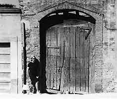 Marcel Duchamp. Exterior door•of Étant donnés in its original setting, with Teeny Duchamp, La Bisbal, early 1960s.