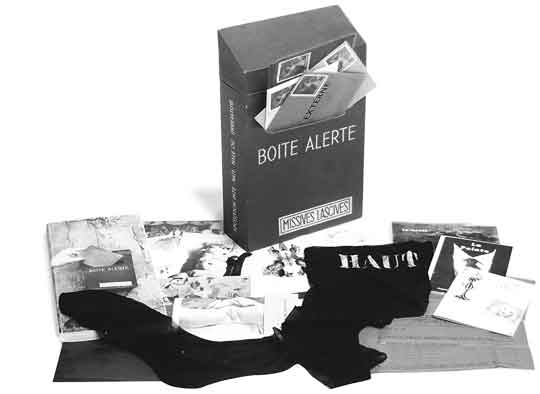 Marcel Duchamp: Boîte alerte (Emergency Box), 1959. Deluxe edition of catalogue for Exposition Intemationale du Surréalisme. Cardboard box containing paperbound catalogue and ephemera. postcards, notes, envciopes, portfolio of artists' prints, printed nylon stocking, and 45 rpm record, 28,6 × 18,1 × 6,4 cm.
