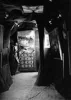 Gallery view of the Exposition inteRnatiOnale du Surrélisme. On the ceiling: Man Ray, Virgin; at rear, left: Giacometti, Invisible Object (Hands Holding the Void); center: Rauschenberg, Bed.