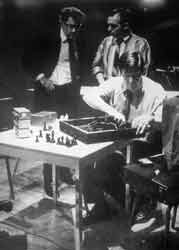 Fragments of Happiness in Art. The Reunion of Electronic Music and Chess. John Cage installs contact microphones inside the chessboard while David Tudor and Lowell Cross confer. 