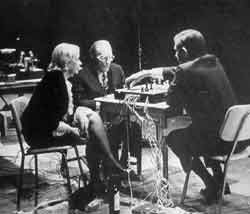 Fragments of Happiness in Art. The Reunion of Electronic Music and Chess. John Cage makes a move; David Behrman and Gordon Mumma in background. Note bottle of wine at Teeny Duchamp’s feet. 